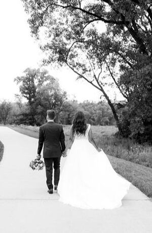 Newly married couple walking away together 